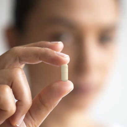 a woman holding a pill 1 copy